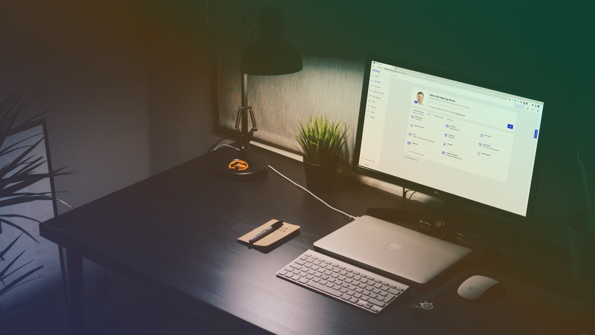 A photo with a desktop computer open on My Intility, designed with Bifrost design system